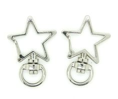 pair of star and circle earrings in silver tone with clip closures on each side