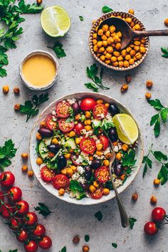 a salad with tomatoes, chickpeas and avocado is served in a bowl