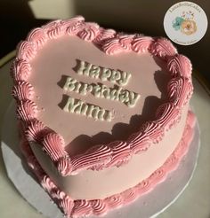 a pink heart shaped birthday cake with the words happy birthday mimi on it's frosting