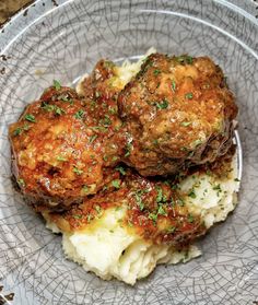 two meatballs and mashed potatoes on a plate