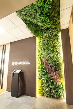 an office lobby with a green wall on the ceiling