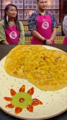 two people wearing pink aprons standing in front of a plate with food on it