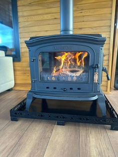 a blue stove sitting on top of a wooden floor