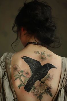 a woman with a bird tattoo on her back