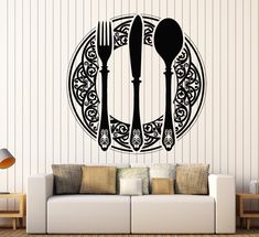 a living room with a couch, table and two forks and spoons on the wall