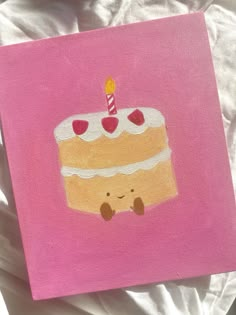 a painting of a cake with a candle on it's top is sitting on a bed