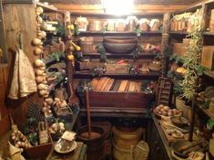 an old fashioned kitchen with lots of pots and pans on the shelves in it