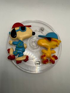 two cartoon figures are sitting on a plastic plate