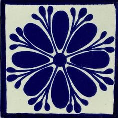 a blue and white tile with an intricate design on it's side, in the shape of a flower