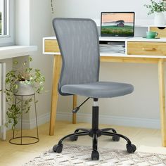 an office chair sitting in front of a computer desk