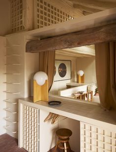 a mirror and stool in a small room