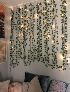 a living room with ivy growing on the wall and lights hanging from it's sides