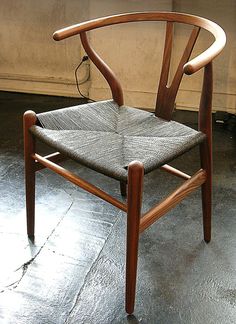 a wooden chair sitting on top of a cement floor