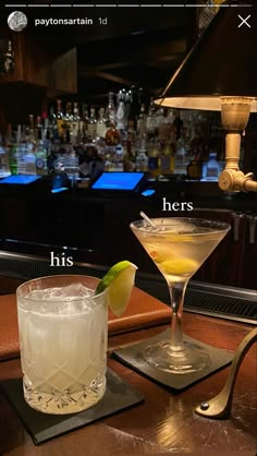 two cocktails sitting on top of a bar next to each other