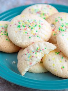 some cookies with sprinkles are on a purple plate