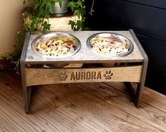 two bowls of food on a wooden table with the word aurora written in black ink