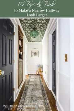 the hallway is decorated in green and white with floral wallpaper on the ceiling, along with an area rug