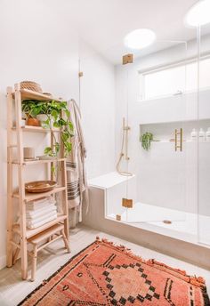 a bathroom with a rug, shelf and shower