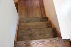 the stairs are made of wood and have been painted white with brown stain on them