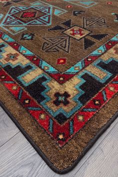 a brown and blue area rug on top of a wooden floor