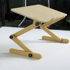 a small wooden table sitting on top of a white floor