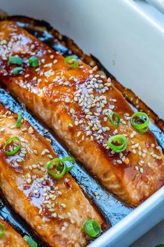 salmon with sesame seeds and green onions in a baking dish