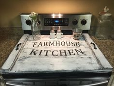 a sign that says farmhouse kitchen on top of an oven