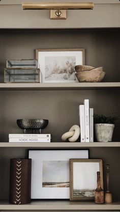 shelves with pictures, books and other items on them