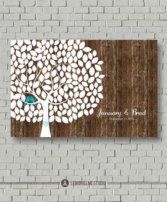 a wooden wall with a white tree and blue bird sitting on the top of it