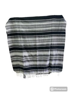 a black and white striped blanket with fringes