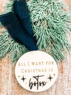 a wooden ornament with the words, all i want for christmas is to love