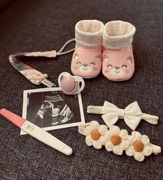 a pair of baby shoes, hair clips and other items