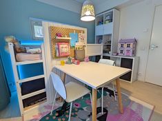 a child's bedroom with bunk beds and desk