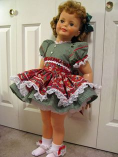 a doll that is standing up against a door