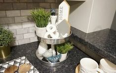 a kitchen counter topped with dishes and cups