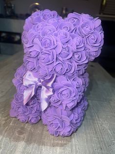 a teddy bear made out of purple roses