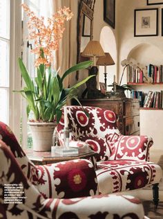 a living room filled with furniture and a potted plant