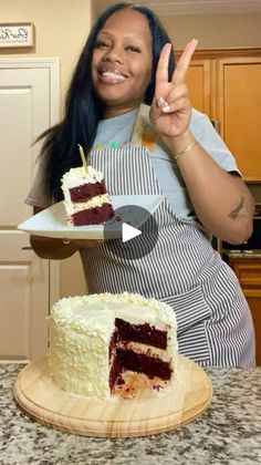 a woman holding up a piece of cake in front of her face and making the peace sign