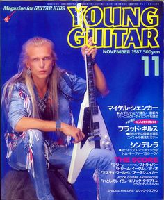 a man sitting on top of a magazine cover holding an electric guitar in his hand