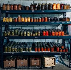 shelves filled with jars and boxes full of different types of sauces on display in a store