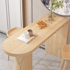 a wooden table with a plant and cup on it