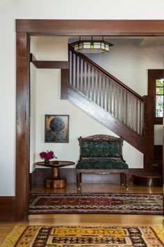 a living room with a stair case next to a couch