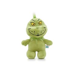 a green stuffed animal with yellow eyes and an angry grin on it's face