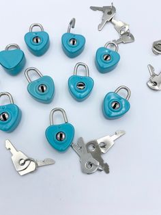 several blue heart shaped padlocks are arranged in a circle on a white surface