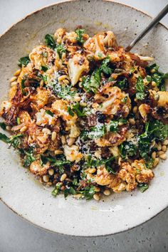 a white bowl filled with food on top of a table