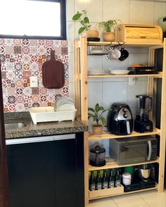 a kitchen area with coffee maker, sink and shelves