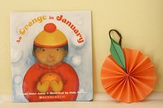 an orange ornament next to a children's book about orange in january