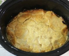 a crock pot filled with food sitting on top of a table