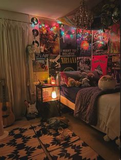 a bed room with a neatly made bed and lots of posters on the wall