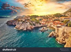 an aerial view of the coast and town in croatia at sunset with colorful clouds above